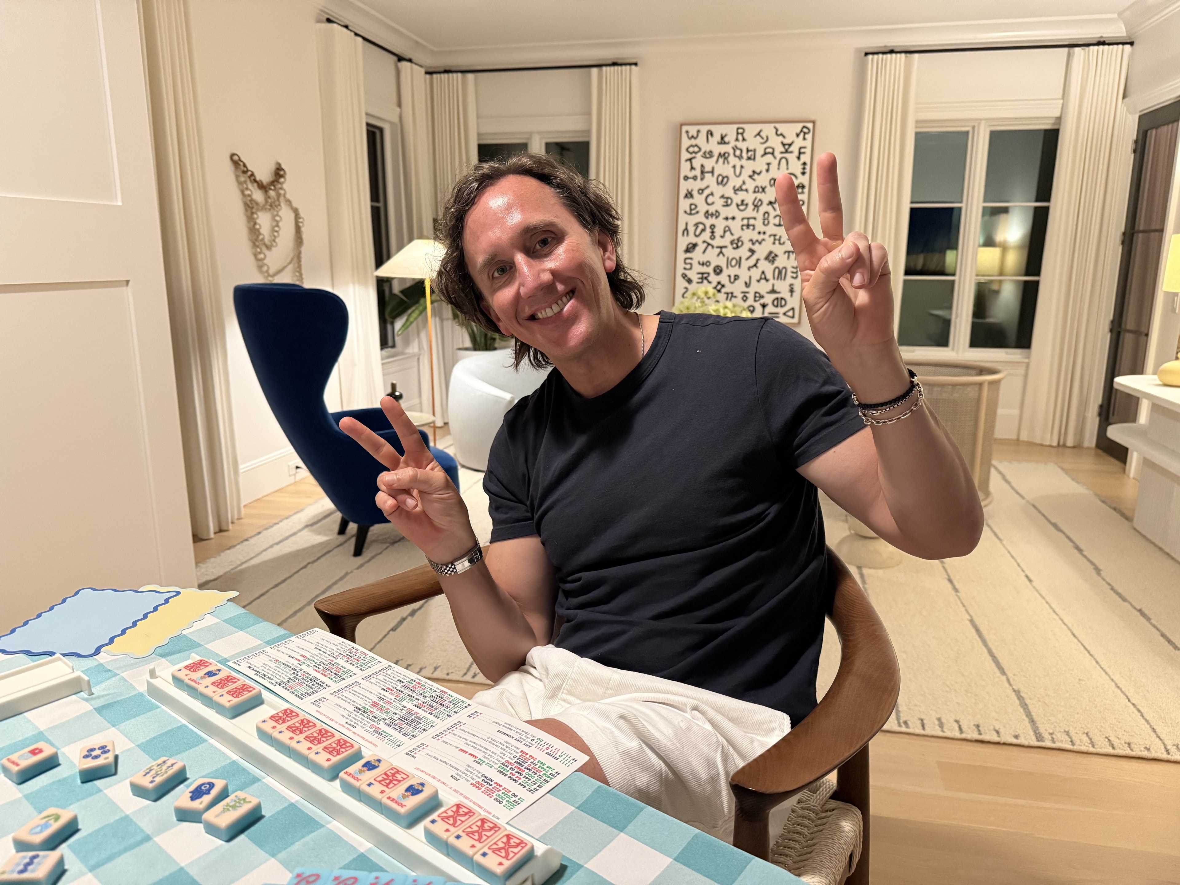 Man holding kitchen-themed game items in a kitchen